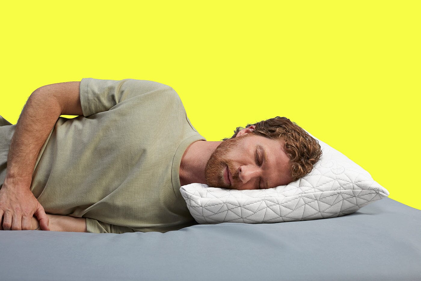 Man sleeping on Coop adjustable pillow