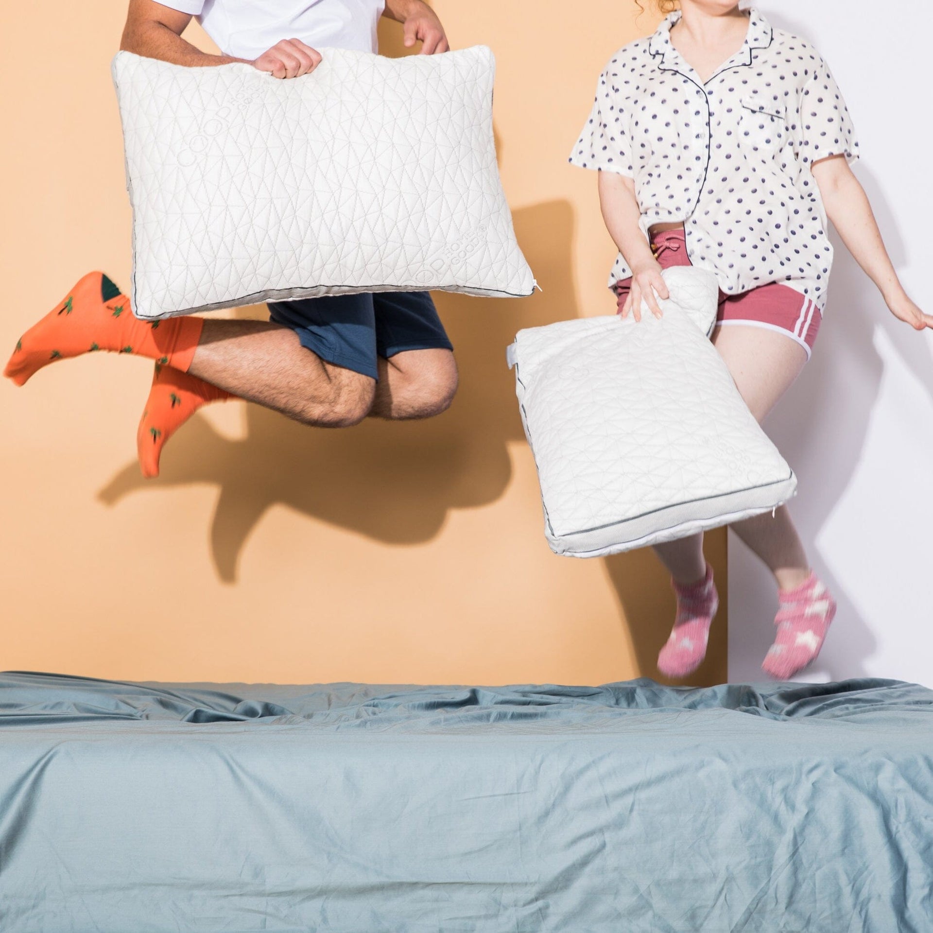 Couple jumping in bed