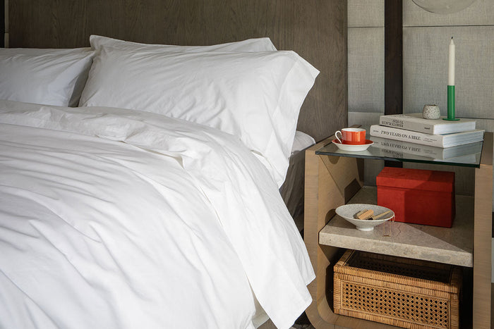 Made bed with white sheets